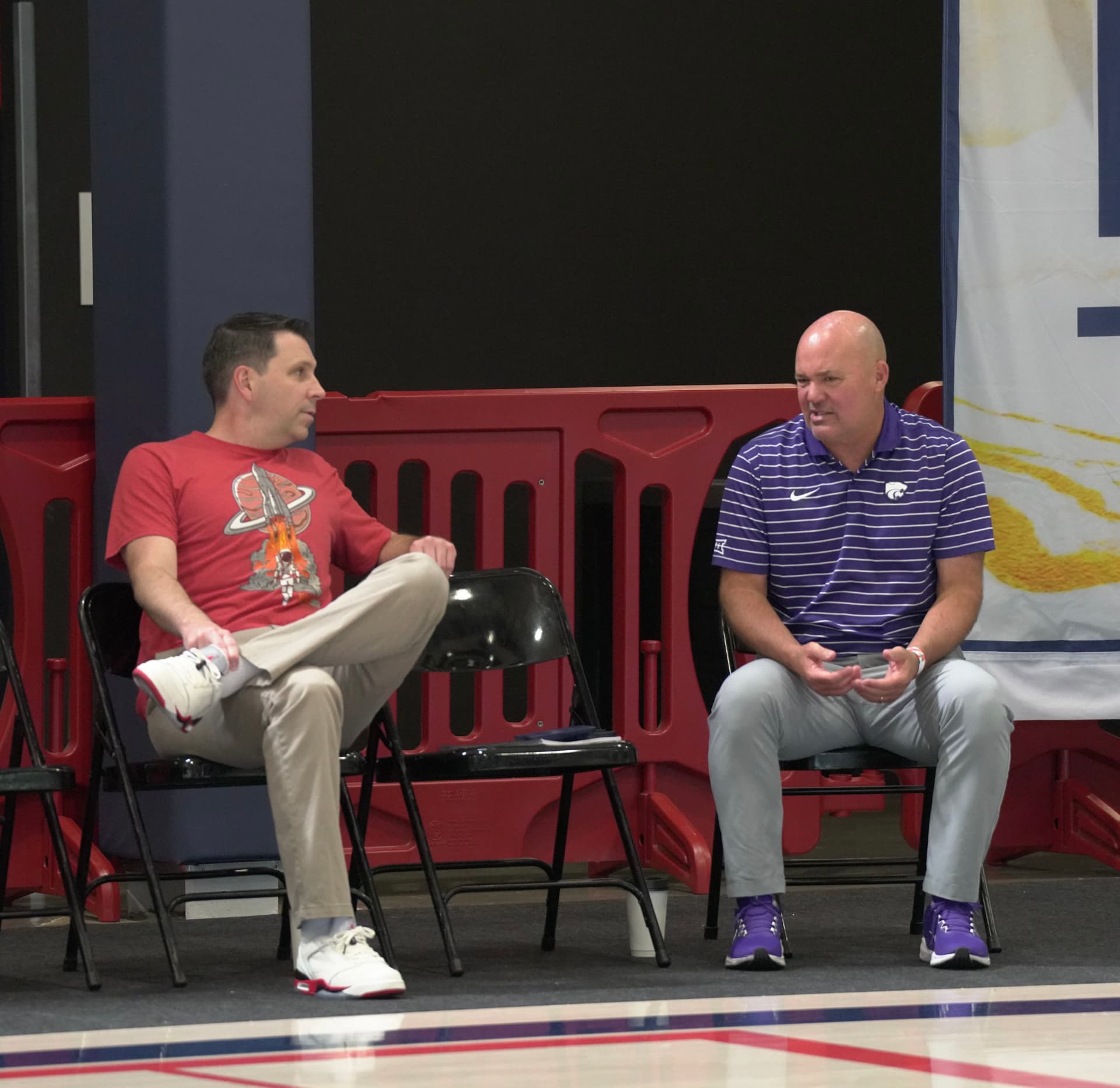Mike Enright speaking with a college coach courtside