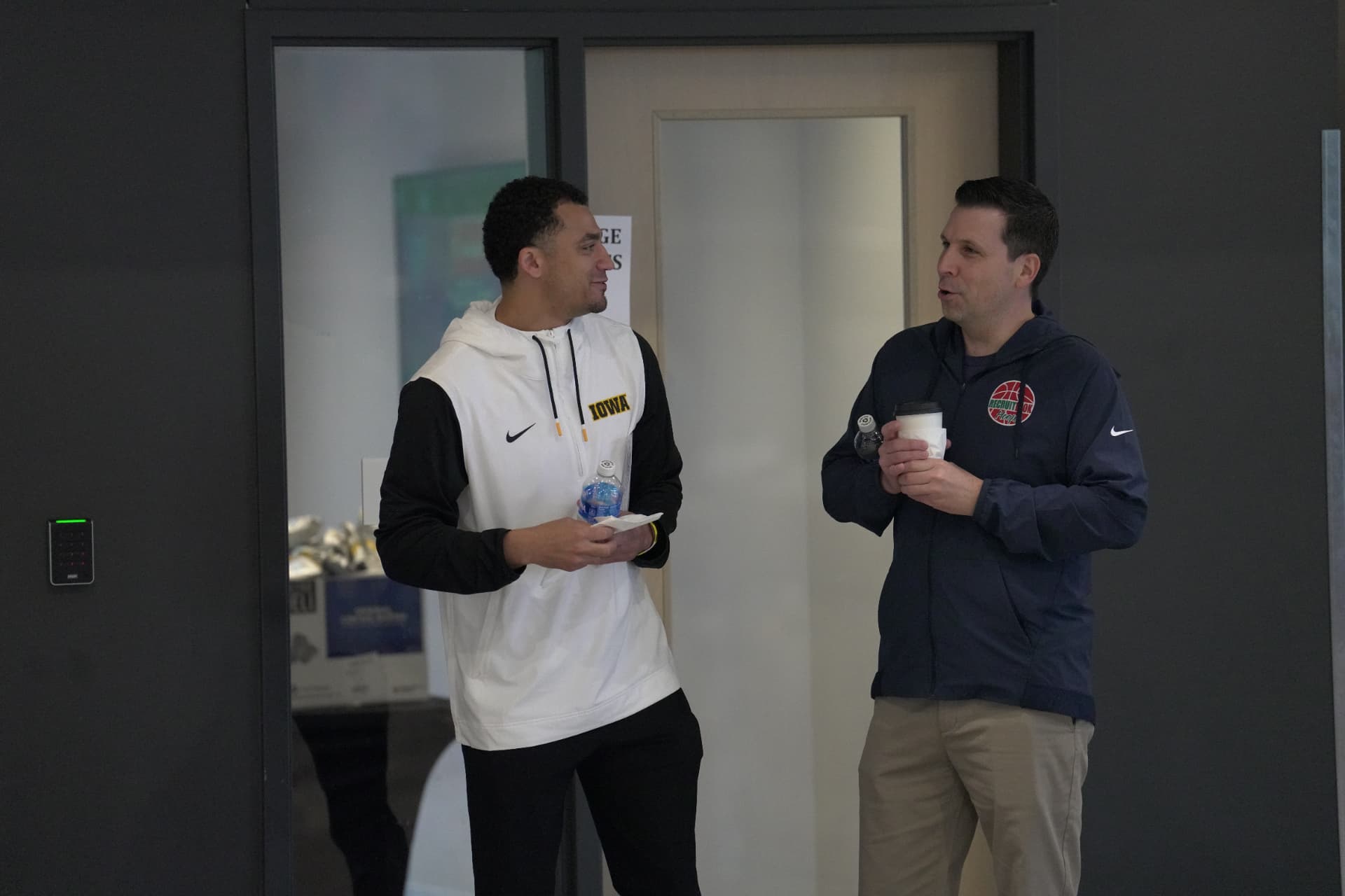 College basketball coaches talking at an event